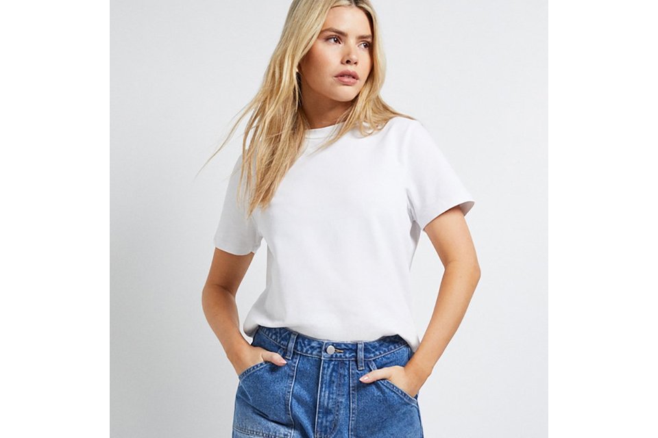 White crew neck T-shirt paired with high-waisted wide-leg blue jeans.