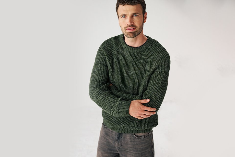 Man wearing dark green knitted jumper.
