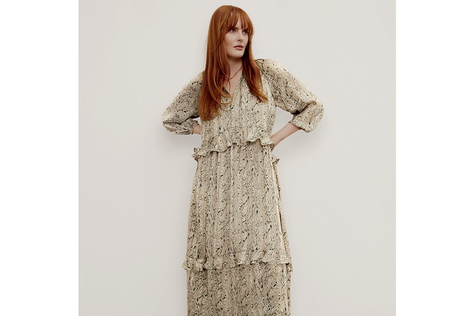 Long-sleeve cream floral midi dress styled for winter occasions.