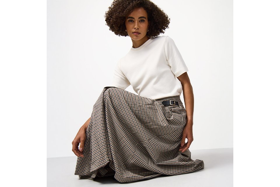 Model wearing a white T-shirt and checked maxi skirt from the Tu Clothing trends and collections range.
