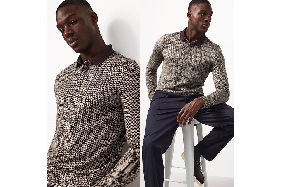 A man wearing a neutral herringbone long sleeve top with smart trousers and lace up shoes.