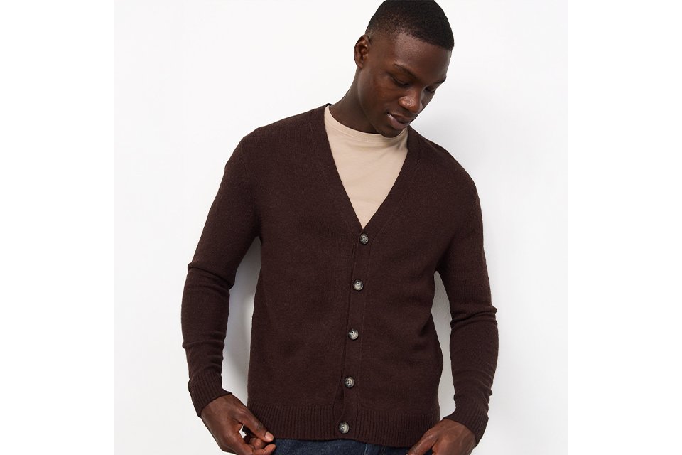 Premium men's knitwear, with a man wearing a neutral basic top, and a brown long sleeve lambswool cardigan.
