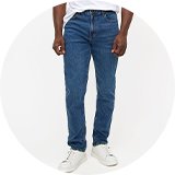 Men's white crew neck T-shirt paired with blue slim-fit jeans and white trainers for a casual everyday look.