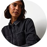 Dark wash denim overshirt with front patch pockets and button fastening, styled for a casual women's denim look.