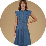 Blue denim midi dress with flutter sleeves, button-front detail, and a fitted waist, styled with heeled sandals.