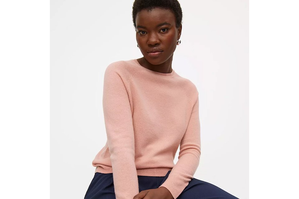 Woman wearing pink cashmere blend jumper.