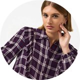 Woman wearing burgundy check shirt.