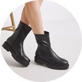 Woman wearing black chunky boots.