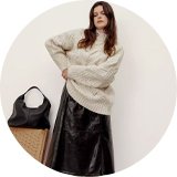 Woman wearing knitted jumper.