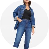 Woman wearing denim shirt and jeans.