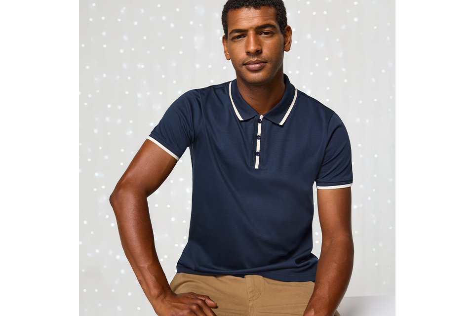 Navy polo shirt styled for men’s smart-casual festive outfit.