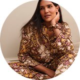 Women's Christmas pyjamas featuring festive winter prints and cosy nightwear styles.