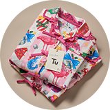Wrapped Christmas pyjama gift set with festive character print nightwear.