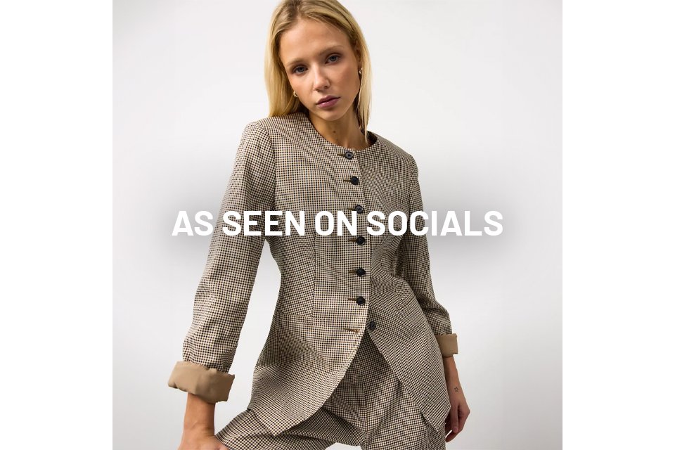 Woman wearing check blazer. 