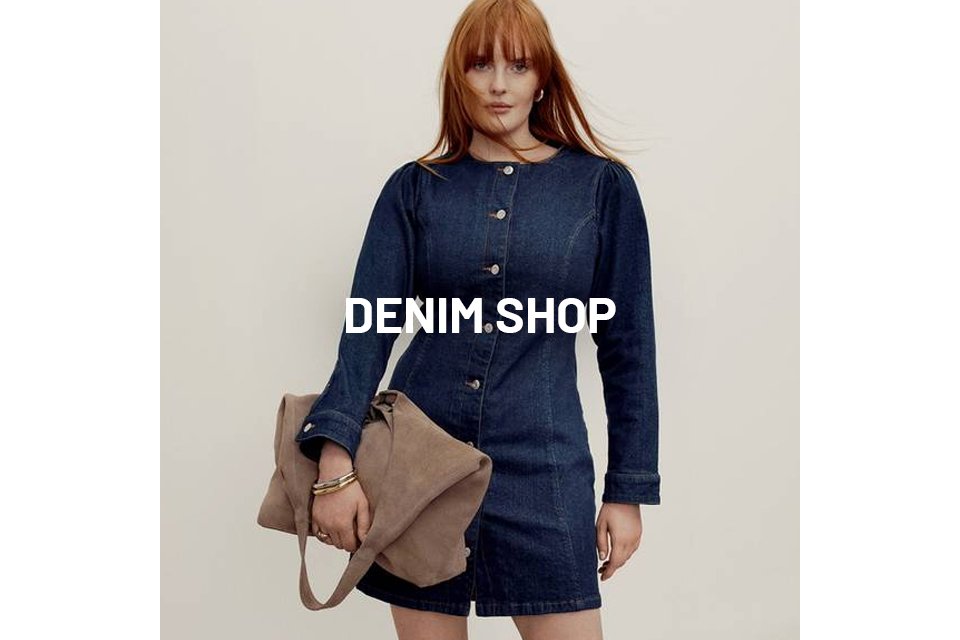 Woman wearing denim button through dress. 