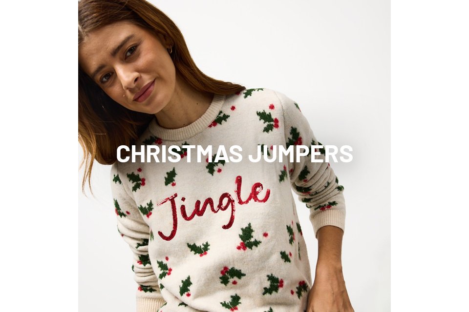 Woman wearing christmas pyjamas with the word jingle on it, and holly leaves.