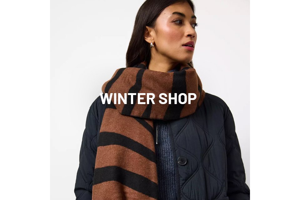 Woman wearing black coat and a brown and black scarf.