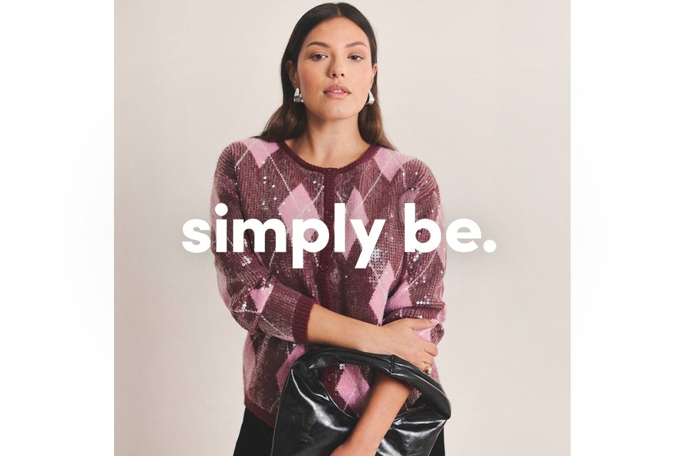 A woman wearing pink and burgundy sequin cardigan.