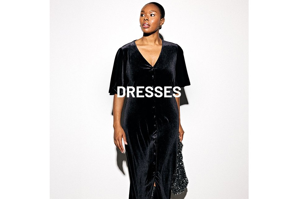 Woman wearing black velvet dress and carrying a black sequin handbag.