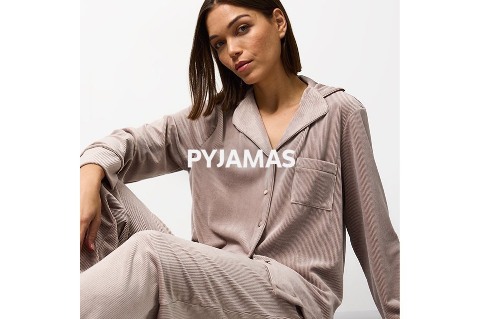 Woman wearing traditional mink ribbed velour pyjamas.