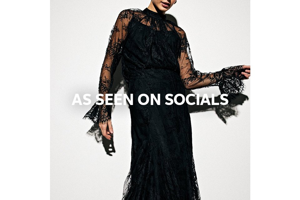 Woman wearing full length black lace skirt. 