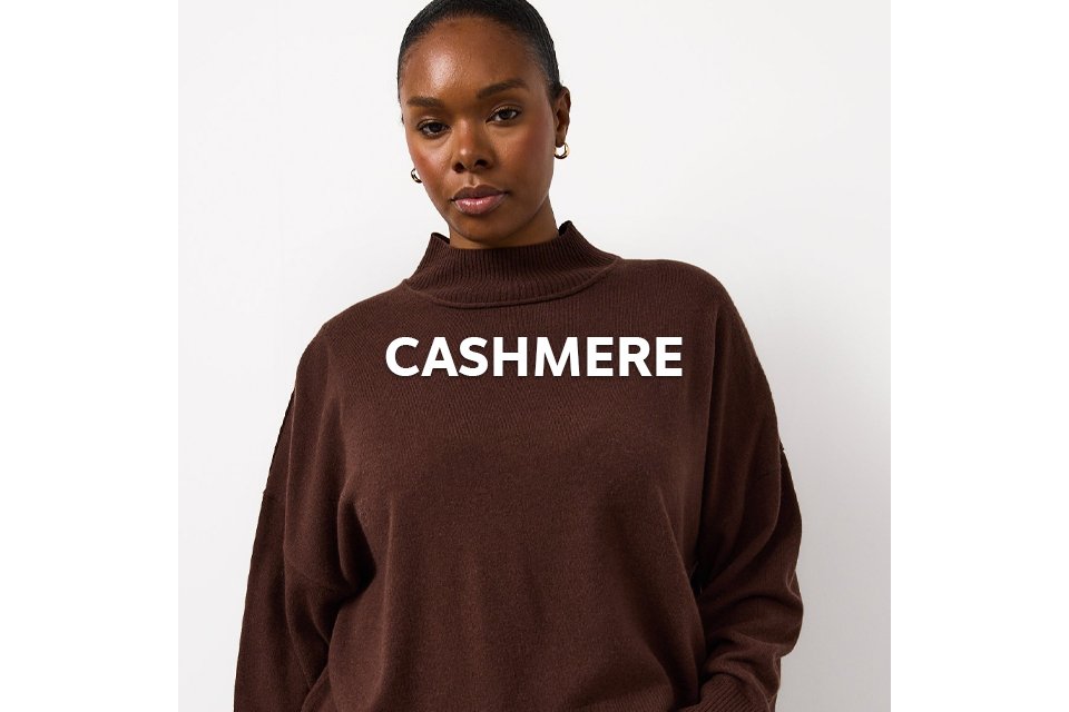 Woman wearing a brown cashmere merino high neckline jumper.