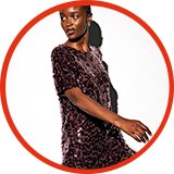 woman in sequin dress and high heel boots.