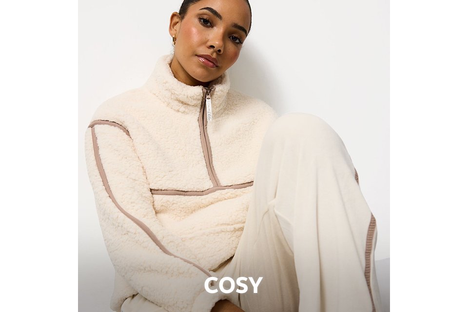 Cream fleece zip-up top paired with loose cream trousers, styled as cosy nightwear.
