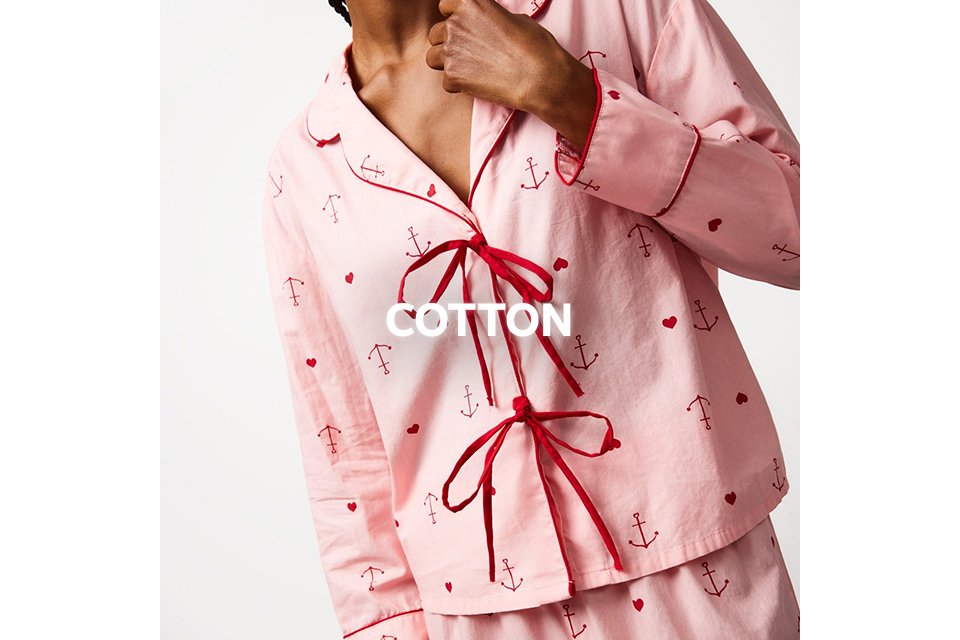 Pink cotton pyjama set with red anchor and bow print.