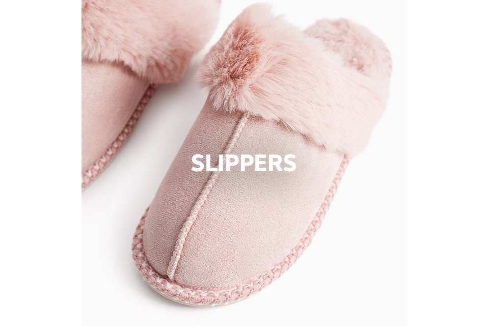 Pair of soft pink slippers with fluffy faux fur trim.