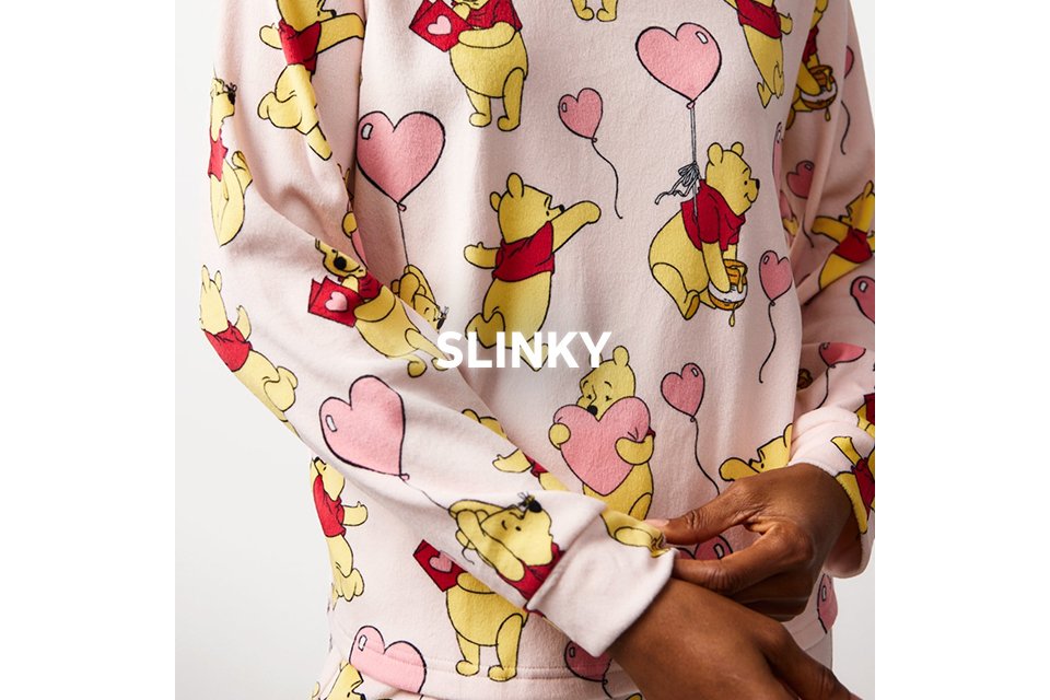 White slinky nightwear with Winnie the Pooh and pink balloon print.