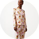 Full-length pyjama set with pink check and red hearts.