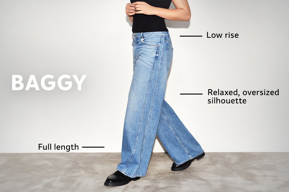 Mid-rise wide baggy jeans in light blue denim with full-length style, worn with black top and shoes.