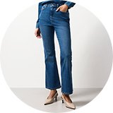 Blue denim jeans styled with rolled cuffs and casual footwear.