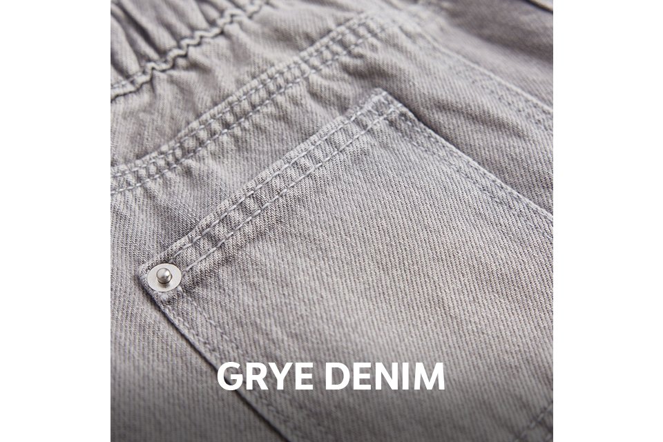 Close-up of the back of light grey denim jeans featuring an elasticated waistband, belt loops, and a back pocket with rivet detailing.