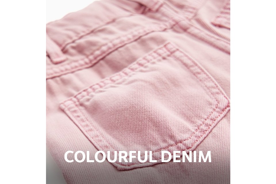 Close-up of the back pocket and waistband of pink denim jeans, featuring tonal stitching and a classic five-pocket design.