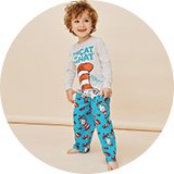 Person wearing a dark top and patterned pyjama bottoms. 