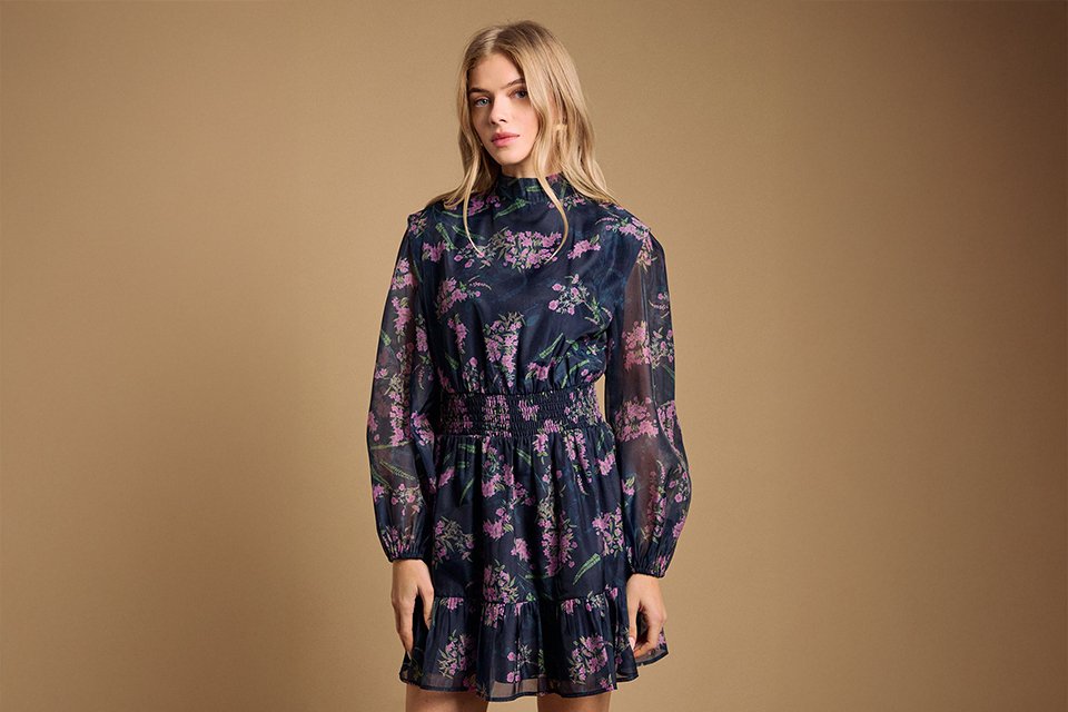  Dark floral long-sleeve dress styled for an evening wedding reception with a refined, occasion-ready finish.